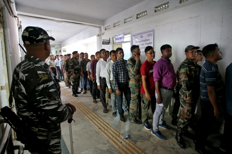 Security personnel stand in line on April 16, 2024 to cast absentee ballots at a polling station in Agartala ahead of India’s general election, which runs from April 19 to June 1.
