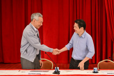 Singapore Prime Minister Lee Hsien Loong shakes hands with
Finance Minister Lawrence Wong on April 16, 2024, during a news conference at the Istana, in Singapore.
