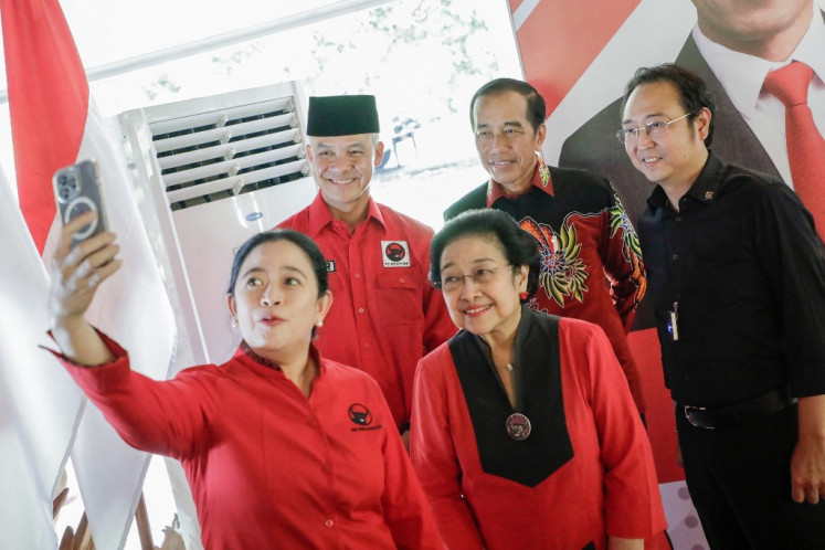 This handout picture taken and released on April 21, 2023 by the Indonesian Democratic Party of Struggle shows party senior official (front left to right) Puan Maharani, chair Megawati Soekarnoputri, (back left to right) former Central Java governor Ganjar Pranowo, President Joko “Jokowi“ Widodo and Megawati's son Prananda Prabowo Suro taking a selfie after Ganjar was selected by the country's largest political party as its candidate for the 2024 presidential election in Bogor on April 21, 2023.