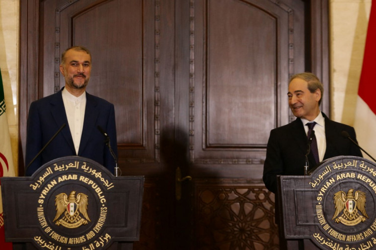 Iranian Foreign Minister Hossein Amir-Abdollahian (left) and his Syrian counterpart Faisal Mekdad hold a press conference at the Foreign Ministry in Damascus on April 8, 2024. 