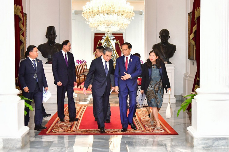 This handout picture taken and released on April 18, 2024 by the Presidential Palace shows President Joko "Jokowi" Widodo (second right) meeting with China's Foreign Minister Wang Yi (third left) at the Palace in Jakarta.