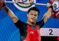 Rizki Juniansyah makes weightlifting look light and easy in this undated handout photo from the International Weightlifting Federation (IWF). Rizki beat out compatriot Rahmat Erwin on April 4, 2024 at the IWF World Cup in Phuket, Thailand, to clinch a spot for Indonesia at the Paris 2024 Summer Olympics.