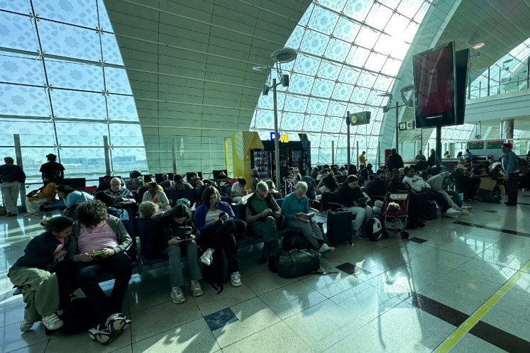 Passengers wait for their flights at the Dubai International Airport in Dubai on April 17, 2024. 