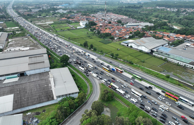 Vehicles stand in bumper-to-bumper traffic on April 15, 2024 in the Jakarta-bound lanes of the Jakarta-Cikampek Toll Road in Karawang, West Java. Police imposed a counterflow system on the toll road for two lanes between Kilometer Marker (KM) 72 and KM 66 and one lane from KM 47 to 36 to manage ‘mudik’ (exodus) return traffic during Idul Fitri this year.