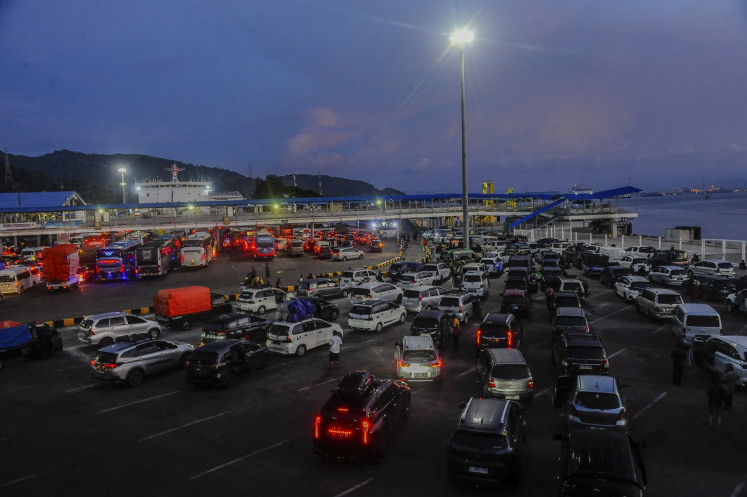Cars line up to board the ferry at Merak Port in Cilegon, Banten on April 15, 2024.