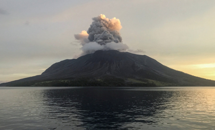 Mount Ruang, located in the Sangihe Islands chain in North Sulawesi’s Siau Tagulandang Biaro (Sitaro) Islands regency, spews a column of ash as it erupts on April 19, 2024, as seen from neighboring Tagulandang Island.