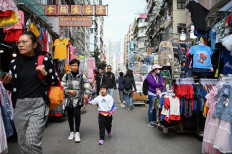 People walk through a market street in the Kowloon district of Hong Kong, China, on Feb. 27, 2024.