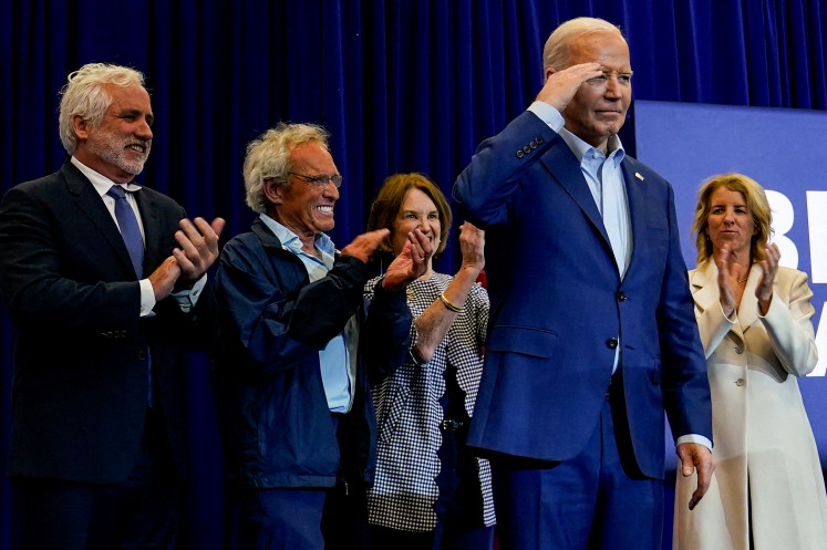 United States President Joe Biden salutes on April 18, 2024, next to members of the Kennedy family, at a campaign event at the Martin Luther King Recreation Center in Philadelphia, Pennsylvania, US.