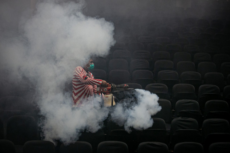 A volunteer fumigates a church on April 19, 2024 in Surakarta, Central Java, as part of the city administration’s efforts to prevent the spread of dengue fever.