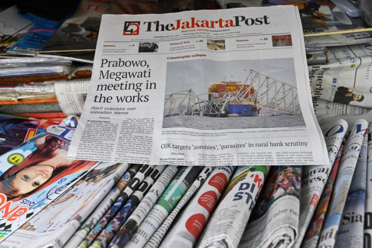 This photo illustration taken on March 27, 2024 in Jakarta shows the front page of The Jakarta Post newspaper with a photo of the Francis Scott Key Bridge following its collapse after being hit by the container ship Dali in Baltimore, Maryland, on March 26.