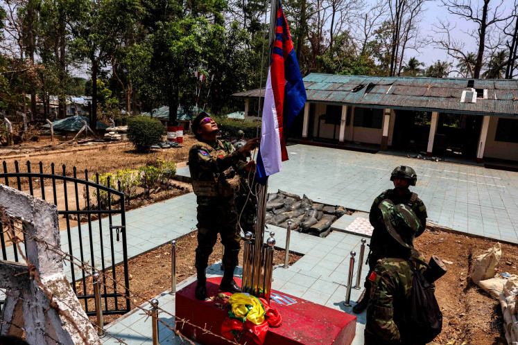 FILE PHOTO: LT Saw Kaw, a soldier of the Karen National Liberation Army (KNLA) in charge of the Cobra column, raises Karen's national flag after burning Myanmar's national flag at a Myanmar military base at Thingyan Nyi Naung village on the outskirts of Myawaddy, the Thailand-Myanmar border town under the control of a coalition of rebel forces led by the Karen National Union, in Myanmar, April 15, 2024. REUTERS/Athit Perawongmetha/File Photo