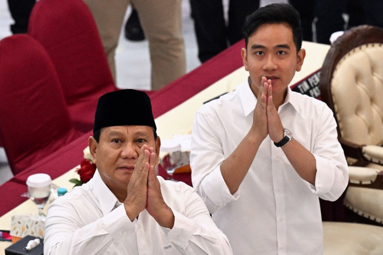 President-elect Prabowo Subianto (left) and vice president-elect Gibran Rakabuming Raka gesture on April 24, 2024, as they arrive at a General Elections Commission (KPU) plenary meeting on the 2024 presidential election results in Jakarta. 