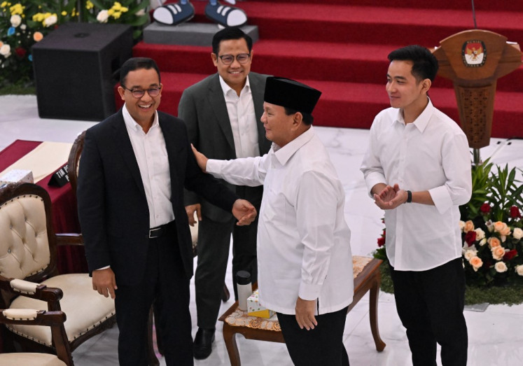 President-elect Prabowo Subianto (second right) and vice president-elect Gibran Rakabuming Raka (right) talk to presidential candidate Anies Baswedan (left) and vice presidential candidate Muhaimin Iskandar (second left) during the plenary meeting of General Elections Commission (KPU) announcing the 2024 presidential election result in Jakarta on April 24, 2024.