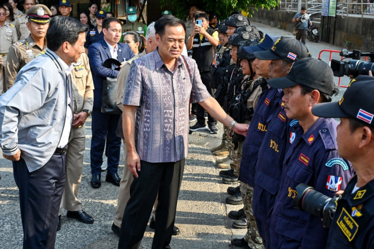 Thai Foreign Minister Parnpree Bahiddha-Nukara (center) and Thai Interior Minister Anutin Charnvirakul (left) greet officials during a visit to survey the area along the border following clashes in Myanmar, in Thailand's Mae Sot district on April 23, 2024. 