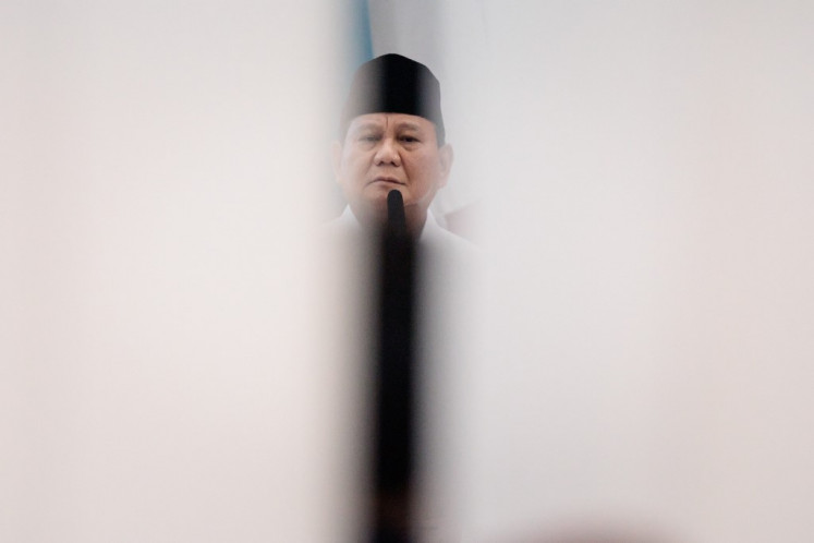 President-elect Prabowo Subianto is seen on April 24, 2024 through a gap in the door during a meeting of the General Elections Commission (KPU) in Jakarta to announce the results of the 2024 presidential election.