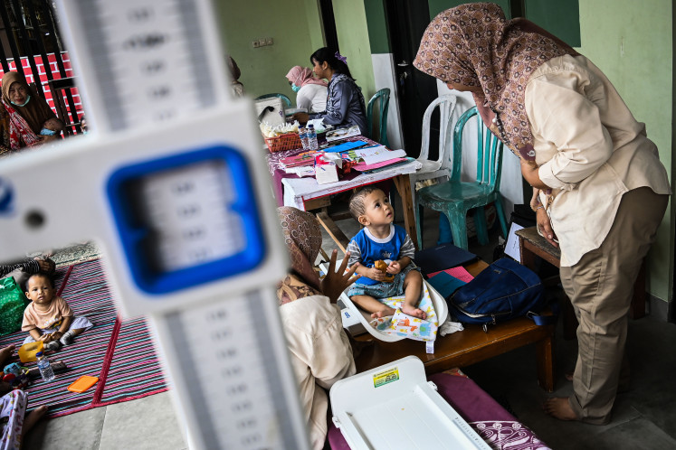 A health worker performs a medical check
on a child to determine if they are fit to receive a vaccine on April 24, 2024. The
Health Ministry is running a nationwide, weeklong vaccination
drive ending on Sunday in observance of World Immunization
Week.