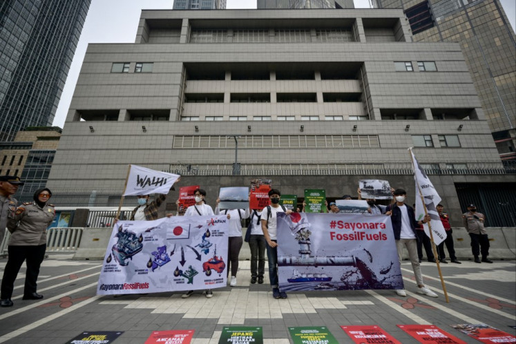 Environmental activists from the Indonesian Forum for the Environment (WALHI) hold a protest to condemn Japan and its export credit agency, the Japan Bank for International Cooperation (JBIC), over the country's public funding for gas and LNG projects in front of Japanese embassy in Jakarta on April 25, 2024. 
