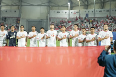 Members of the Indonesian U-23 men's soccer team line up on April 25, 2024, to sing the national anthem before the squad's 2024 AFC U-23 Asian Cup quarterfinal soccer match against South Korea at Abdullah bin Khalifa Stadium in Doha. 