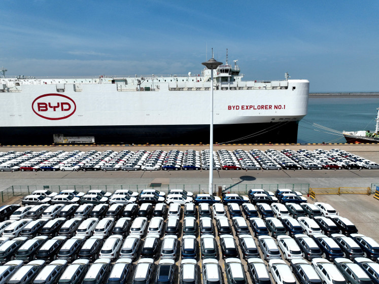 BYD electric vehicles (EVs) line up before being loaded onto the BYD Explorer No. 1 roll-on, roll-off vehicle carrier for export to Brazil, at the port of Lianyungang in Jiangsu province, China, on April 25, 2024.