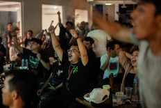 Indonesian football fans react as they watch the U23 AFC Qatar 2024 Asian Cup quarter-final match between Indonesia and South Korea at a cafe in Bekasi, West Java, on April 26, 2024. 