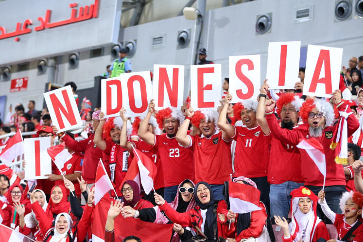 Supporters of Indonesian U-23 men's soccer team cheer during the 2024 AFC U-23 Asian Cup quarter final match between Indonesia and South Korea at Abdullah bin Khalifa Stadium in Doha, Qatar on April 25, 2024 local time. 