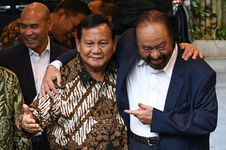 NasDem Party chair Surya Paloh (right) embraces then-president-elect and Gerindra Party chair Prabowo Subianto (left) on Tuesday after a meeting between the two party leaders at Prabowo's residence on Jl. Kertanegara in South Jakarta. Surya, who supported Prabowo's rival Anies Baswedan in the Feb. 14, 2024, election, said he would support Prabowo's administration.
