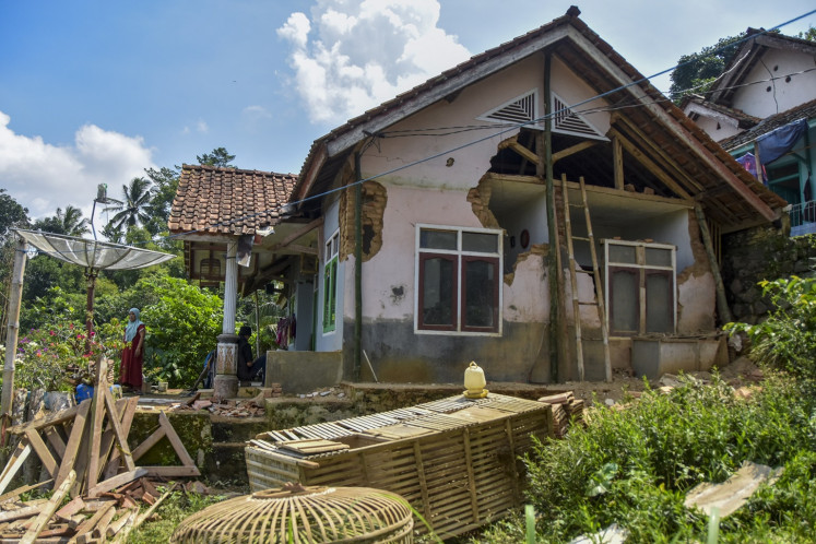 Residents clean rubble from their home on April 28, 2024, in Ciamis regency, West Java. The house sustained damage from a magnitude-6.2 earthquake around 150 kilometers southwest of Garut regency in the same province on the previous night.