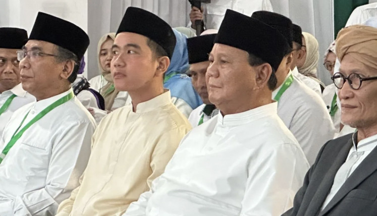 President-elect Prabowo Subianto (second right) sits alongside (from left) Nahdlatul Ulama (NU) chairman Yahya Cholil Staquf and vice president-elect Gibran Rakabuming Raka on April 28, 2024 while attending a halal bi halal (post-Ramadan gathering) of the NU executive board in Jakarta.