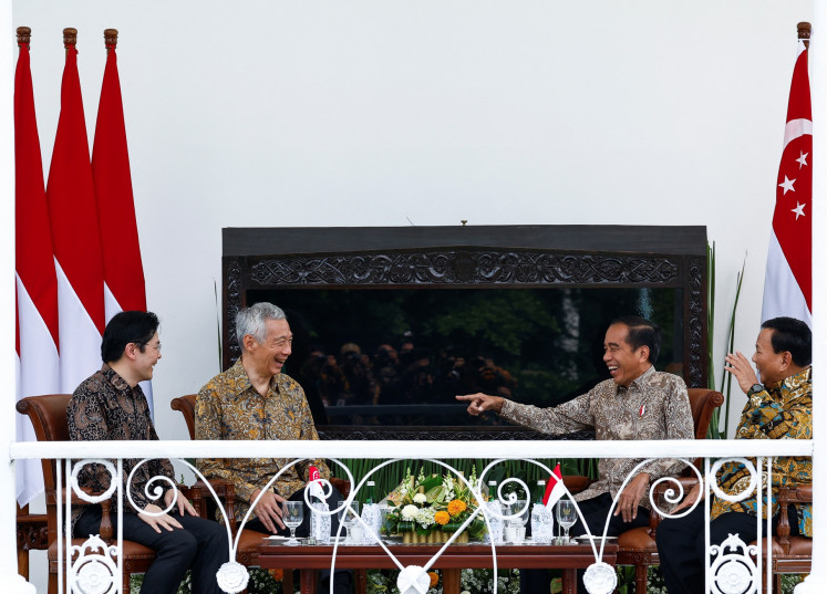 President Joko “Jokowi“ Widodo (second right) talks with Singaporean Prime Minister Lee Hsien Loong (second left) and Deputy Prime Minister and Finance Minister Lawrence Wong (left) as Defense Minister and president-elect Prabowo Subianto (right) looks on, during the leader's retreat at the Bogor Palace in West Java on April 29, 2024.