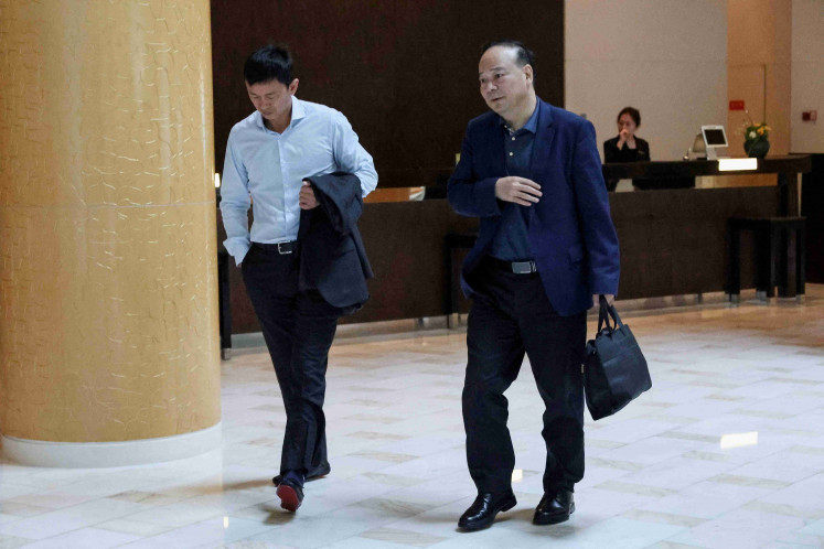 Robin Zeng (right), chairman of Chinese battery giant CATL, walks at a hotel where Tesla CEO Elon Musk is staying, in Beijing, China, April 29, 2024.