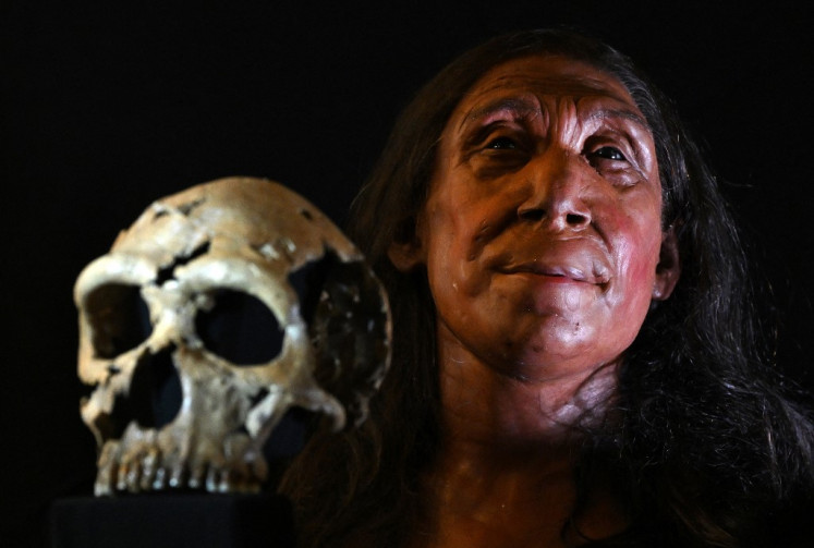 A picture shows the rebuilt skull and a physical reconstruction of the face and head, of a 75,000-year-old Neanderthal woman, named Shanidar Z, after the cave in Iraqi Kurdistan where her skull was found in 2018, at the University of Cambridge, eastern England, on April 25, 2024. 