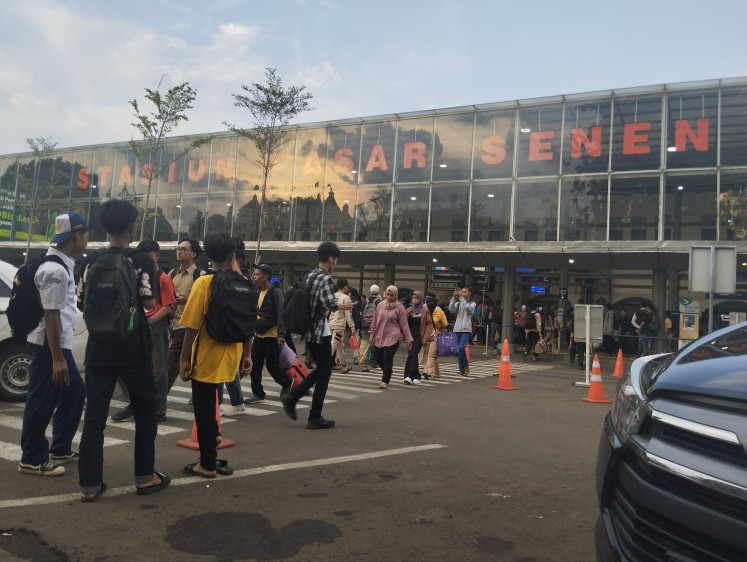 Travel hub: People pass in front of Pasar Senen Station in Central Jakarta on April 18, 2024. The station is a major hub for intercity trains in Jakarta, serving routes from West Java to East Java. (JP)
