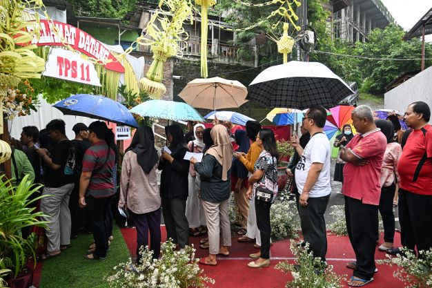 Vox populi: People queue on Feb. 14, 2024 to cast their ballots and vote in the presidential and legislative elections at a polling station in Semarang, Central Java. 