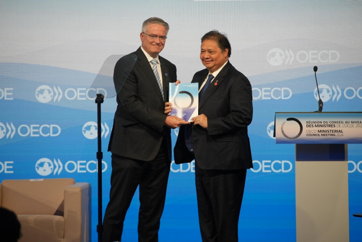 Coordinating Economic Minister Airlangga Hartarto receives the road map for Indonesia's Organization for Economic Co-operation and Development (OECD) membership accession at the opening of the OECD Ministerial Level Meeting in Paris on Feb. 20, 2024.