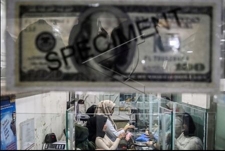 No small change: Tellers serve customers on April 17, 2024 at a money changer in Jakarta as the United States dollar hit a new high of Rp 16,250.