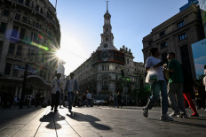 People walk on a pedestrian street in the Huangpu district, in Shanghai, China, on March 30, 2024.