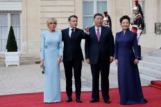 French President Emmanuel Macron (2nd left), his wife Brigitte Macron (left), Chinese President Xi Jinping (2nd right) and his wife Peng Liyuan (right) pose prior to an official state dinner as part of the Chinese president's two-day state visit to France, at the Elysee Palace in Paris, on May 6, 2024. 