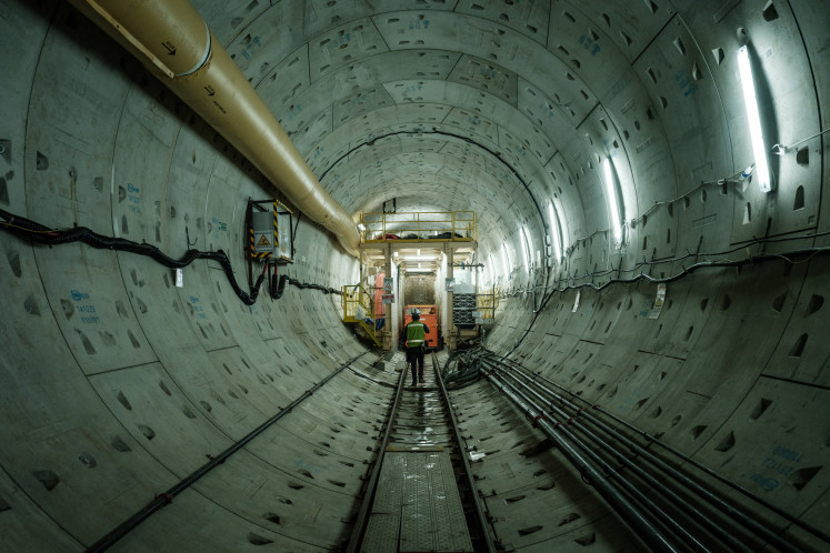 A worker walks on May 7, 2024, at the end of the tunnel construction
site in Jakarta with a tunnel boring machine for the Mass Rapid Transit (MRT)
Phase 2 project, which will extend the current line to the north with loan funding
from the Japan International Cooperation Agency (JICA).