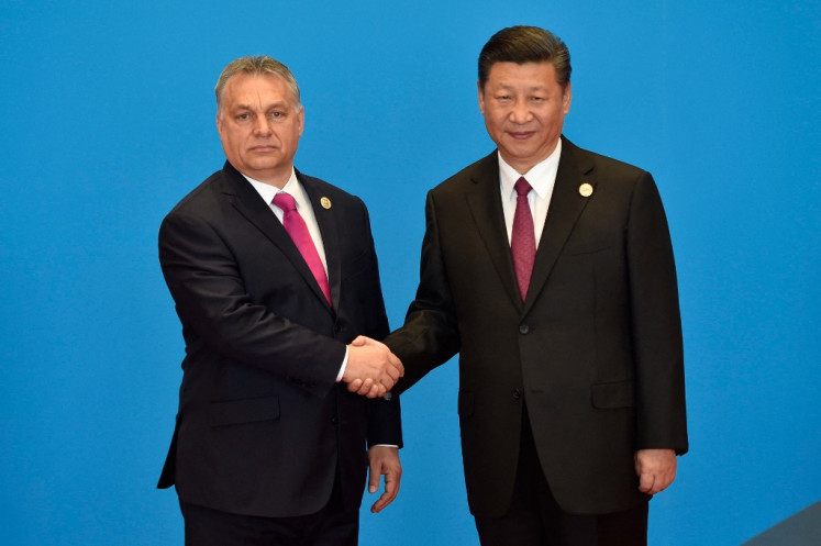 Hungary's Prime Minister Viktor Orban (left) shakes hands with China's President Xi Jinping during the welcome ceremony for the Belt and Road Forum, at the International Conference Center in Yanqi Lake, north of Beijing, on May 15, 2017. 
