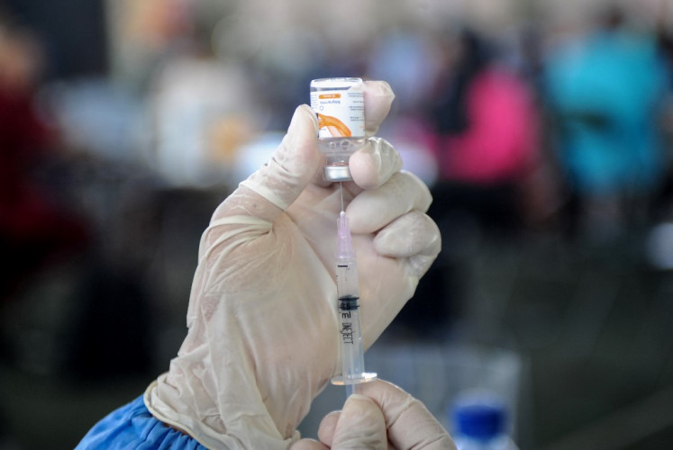 A health worker prepares the AstraZeneca COVID-19 vaccine at a makeshift mass vaccination clinic in Denpasar, Bali, on July 6, 2021, as the Southeast Asian nation battled an unprecedented wave of new infections.