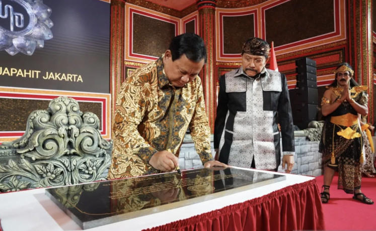 President-elect Prabowo Subianto signs on May 8, 2024, a plaque to mark the start of the construction of a replica of the Majapahit palace, as former National Intelligence Agency (BIN) chief AM Hendropriyono looks on.