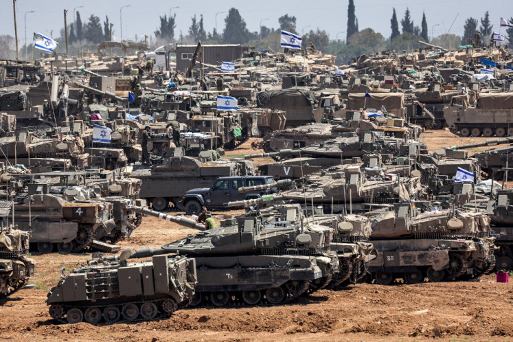 Israeli army main battle tanks and other military vehicles are positioned in southern Israel near the border with the Gaza Strip on May 9, 2024, amid the ongoing conflict in the Palestinian territory between Israel and the Hamas movement. 