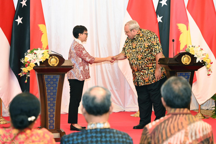 Foreign Minister Retno LP Marsudi shakes hands with her Papua New Guinea counterpart Justin Tkatchenko on May 8, 2024, following a joint statement after the fourth Jakarta-Port Moresby Joint Ministerial Commission (JMC) in Jayapura, Papua.