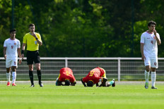 Guinea national team players (center) celebrate their victory at the end of their pre-Olympic play-off match against Indonesia on May 9, 2024, in Clairefontaine-en-Yvelines, France. The teams were competing for the final undecided spot in the men's soccer tournament at this year’s Paris Olympic Games.