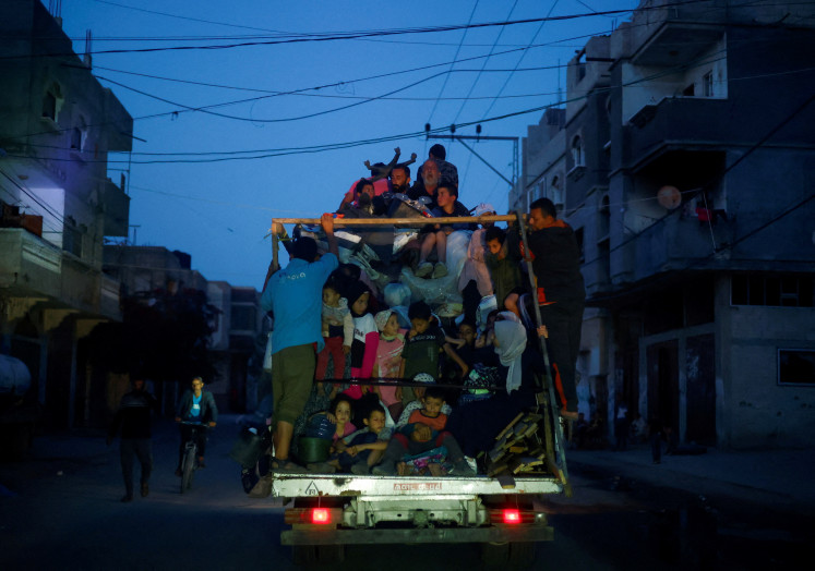 Palestinians ride on a vehicle on May 9, 2024, as they flee Rafah after Israeli
forces launched a ground and air operation in the eastern part of the southern Gaza City, in
the southern Gaza Strip.