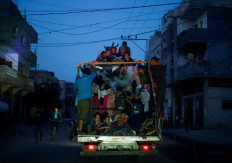 Palestinians ride on a vehicle on May 9, 2024, as they flee Rafah after Israeli
forces launched a ground and air operation in the eastern part of the southern Gaza City, in
the southern Gaza Strip.