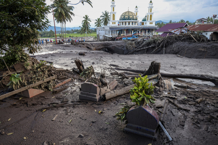 Debris and mud cover the ground in Simpang Manunggal on May 12, 2024, the day after a lahar hit the area in Lima Kaum district, Tanah Datar regency, West Sumatra. Mount Marapi erupted on Saturday evening, leading to the disaster that killed 37 people in the two regencies of Tanah Datar and Agam.