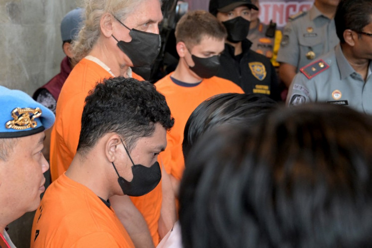 Suspects from Ukraine and Russia are presented to the media following a police raid on a suspected drug lab in Tibubeneng village, Badung regency in Bali on May 13, 2024.