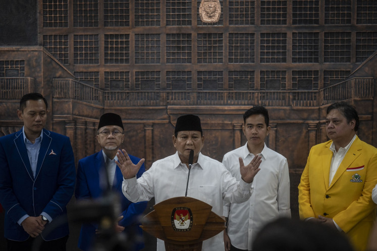 President-elect Prabowo Subianto (center), accompanied by vice president-elect Gibran Rakabuming Raka (second right), National Mandate Party (PAN) chair Zulkifli Hasan (second left), Golkar Party chair Airlangga Hartarto (right) and Democratic Party chair Agus Harimurti Yudhoyono, talks to the press after the General Elections Commission (KPU) officially certified the incumbent defense minister as the winner of the 2024 election, at the poll body's headquarters in Jakarta on April 24, 2024.