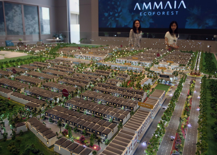Visitors look at a scale model of a
housing complex on April 24, 2024, at an exhibition in
Tangerang, Banten. The government is considering creating a standalone ministry for housing issues,
including to address what it says is a backlog of 12.7
million homes.